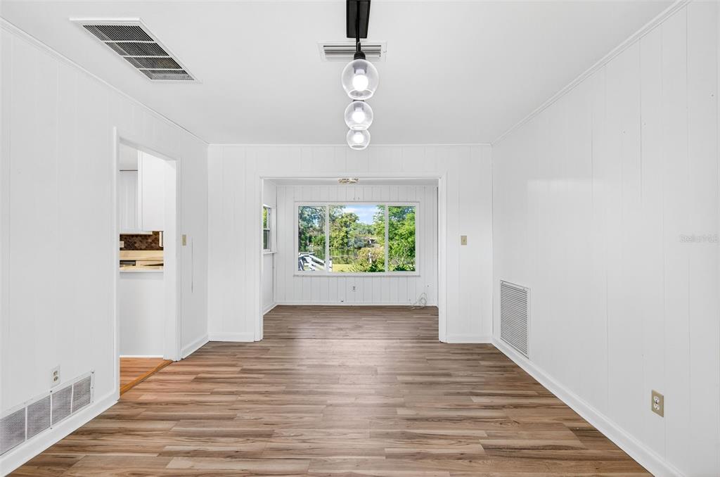 1520 South Keene Road Clearwater, FL 33756 - Photo 11 of 60 wooden floor in an empty room with a window