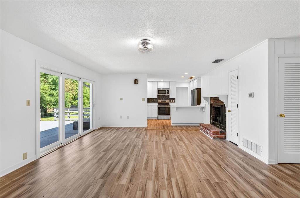 1520 South Keene Road Clearwater, FL 33756 - Photo 14 of 60 a view of a living room with wooden floor and a window