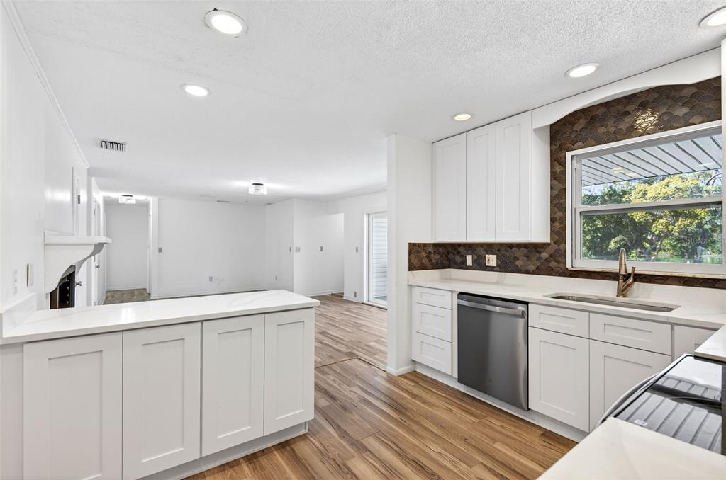 1520 South Keene Road Clearwater, FL 33756 - Photo 18 of 60 a kitchen with a sink stove and cabinets