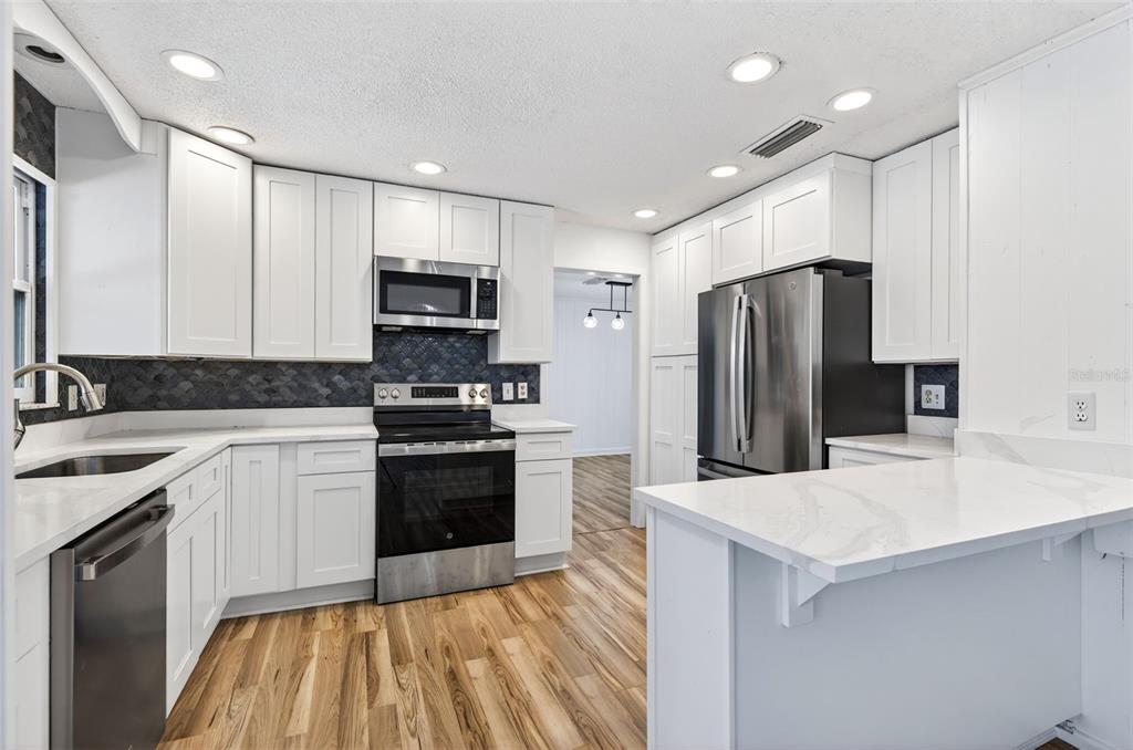 1520 South Keene Road Clearwater, FL 33756 - Photo 21 of 60 a kitchen with stainless steel appliances a refrigerator sink and microwave