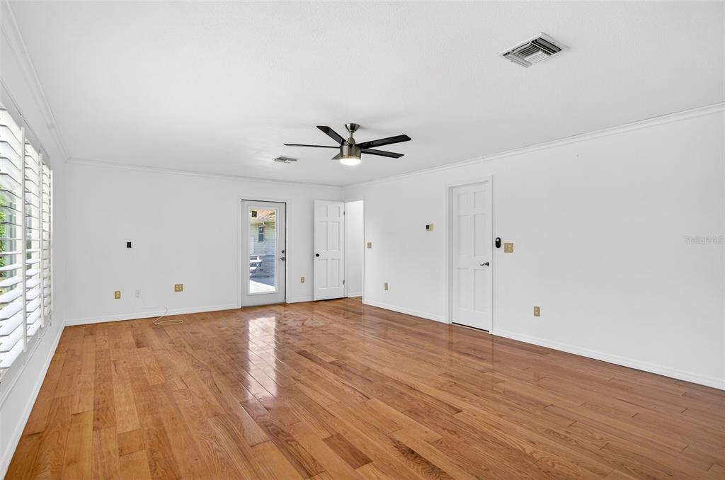 1520 South Keene Road Clearwater, FL 33756 - Photo 26 of 60 a view of a room with wooden floor and a ceiling fan