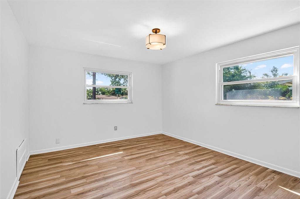 1520 South Keene Road Clearwater, FL 33756 - Photo 32 of 60 a view of empty room with window and wooden floor