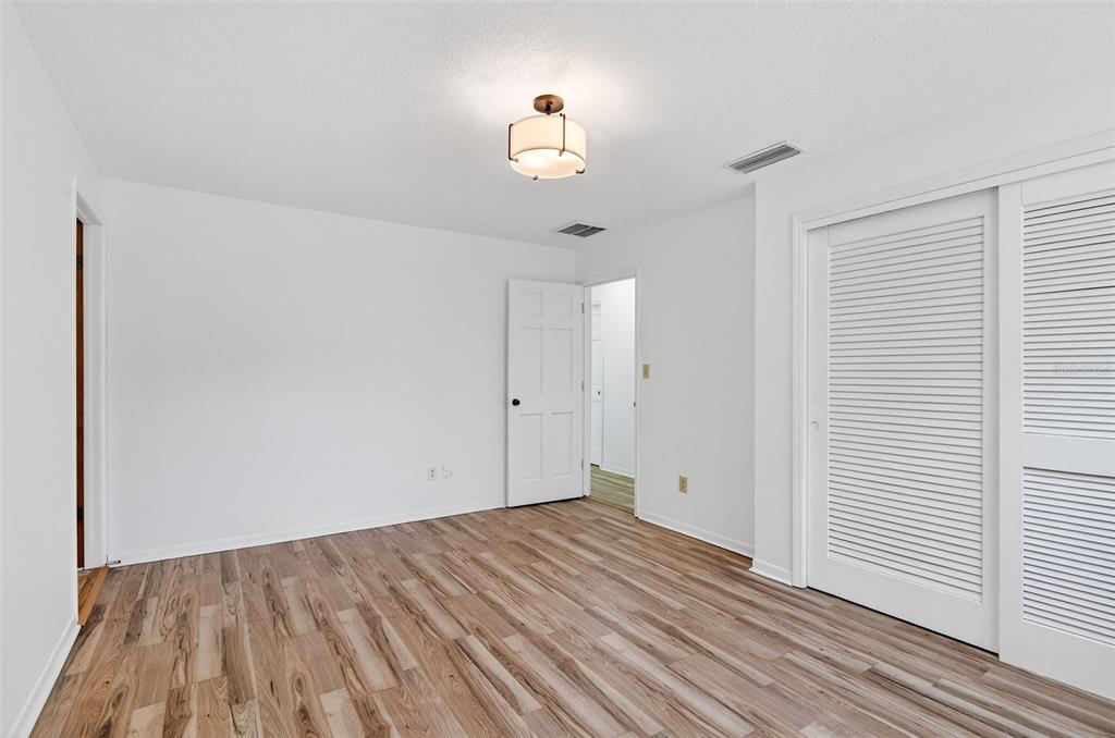 1520 South Keene Road Clearwater, FL 33756 - Photo 33 of 60 a view of empty room with wooden floor and fan