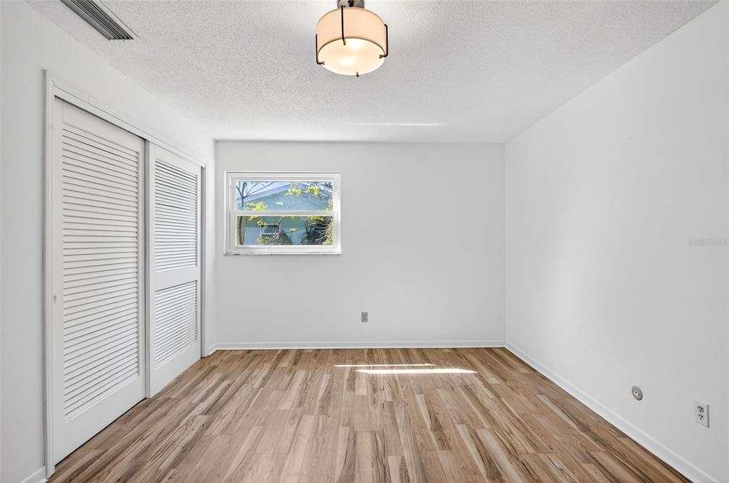 1520 South Keene Road Clearwater, FL 33756 - Photo 34 of 60 wooden floor in an empty room with a window