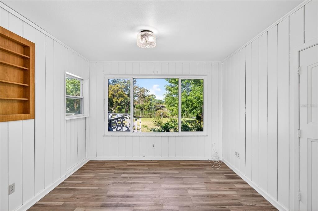 1520 South Keene Road Clearwater, FL 33756 - Photo 37 of 60 a view of an empty room with wooden floor and a window