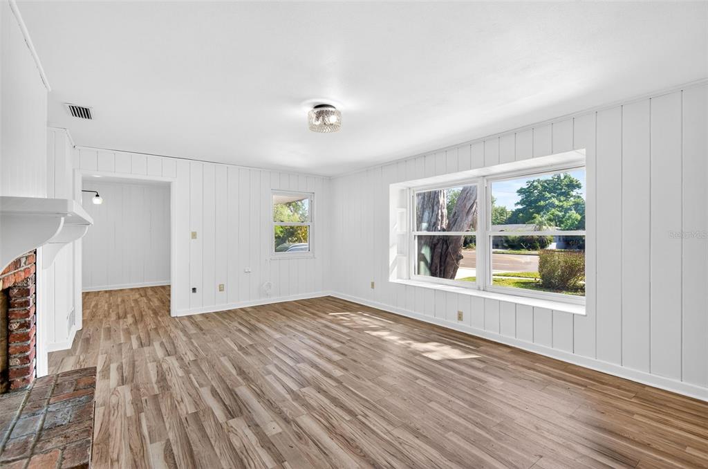 1520 South Keene Road Clearwater, FL 33756 - Photo 6 of 60 an empty room with wooden floor and windows