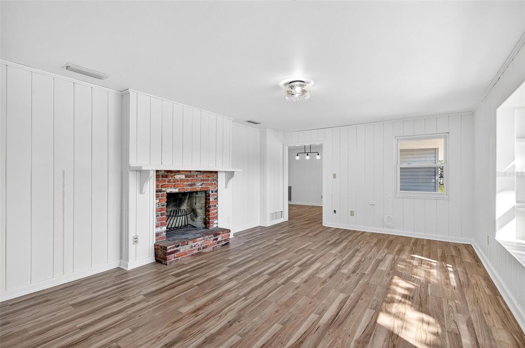 1520 South Keene Road Clearwater, FL 33756 - Photo 7 of 60 a view of a room with wooden floor and a window