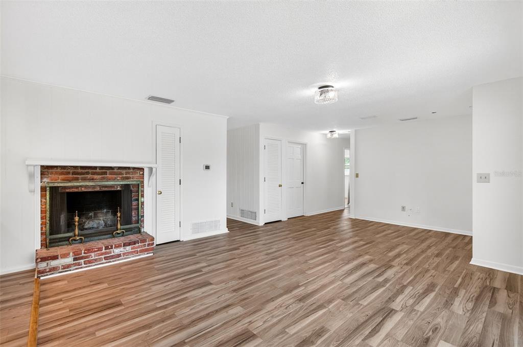 1520 South Keene Road Clearwater, FL 33756 - Photo 8 of 60 a view of empty room with wooden floor and fireplace