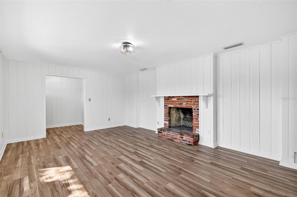 1520 South Keene Road Clearwater, FL 33756 - Photo 9 of 60 a bedroom with a bed and a chandelier