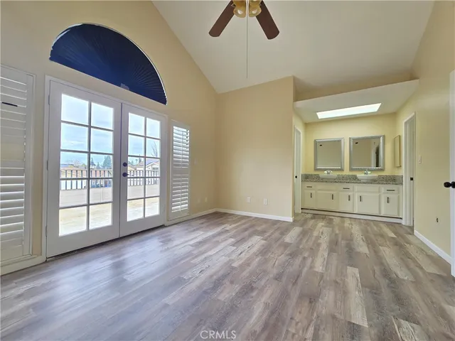 an empty room with closet and windows