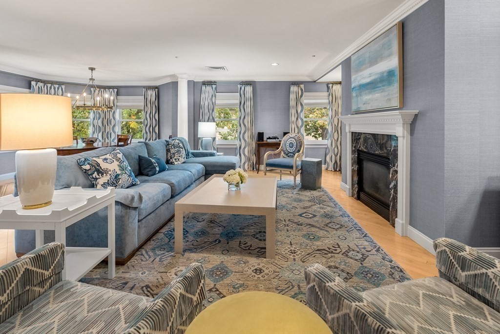 1160 Beacon Street, Unit 301 Brookline, MA 02446 - Photo 3 of 18 a living room with furniture a large window and a fireplace