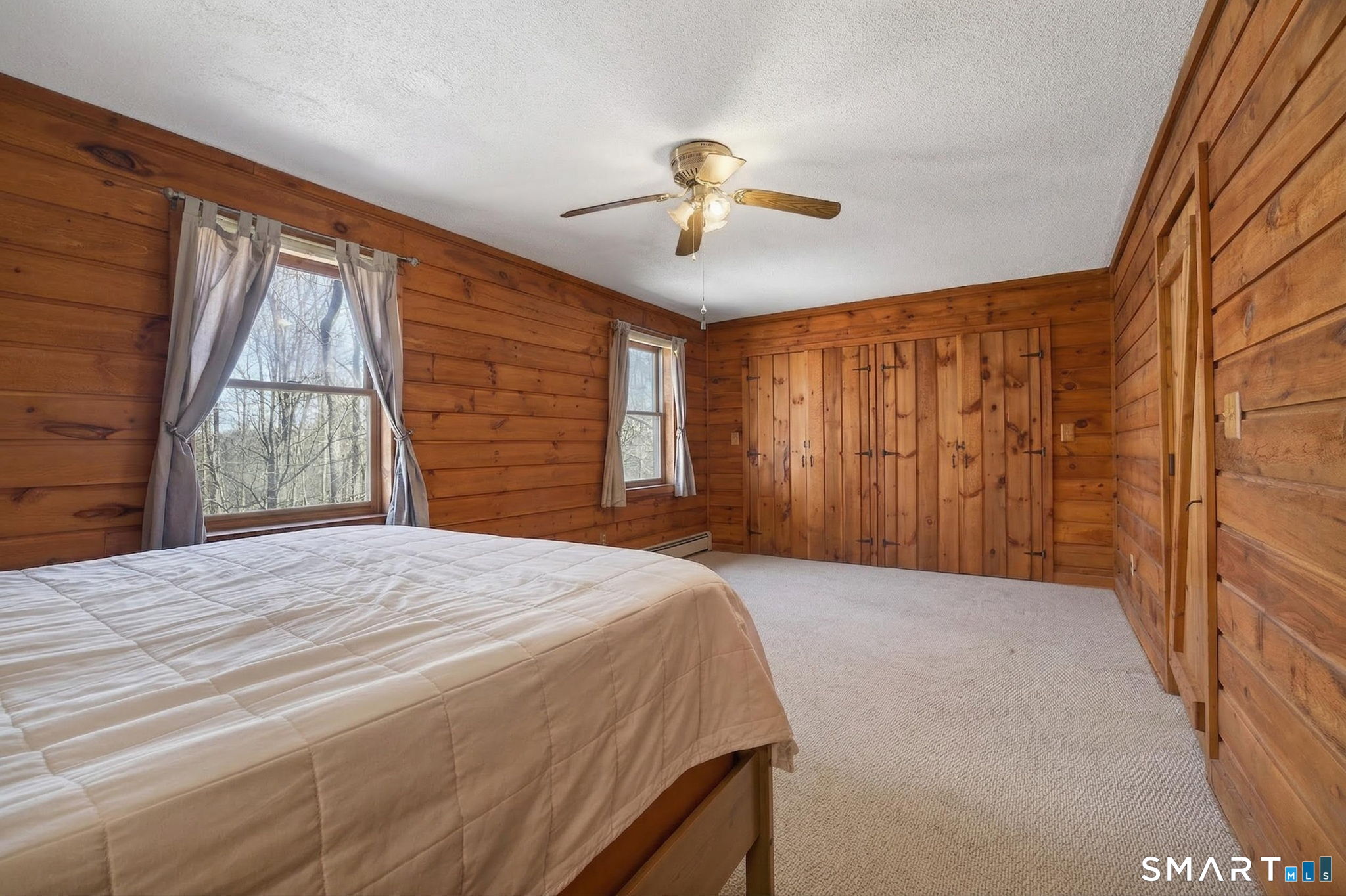 737 Shepard Avenue Hamden, CT 06514 - Photo 22 of 33 a bedroom with a bed and a chandelier