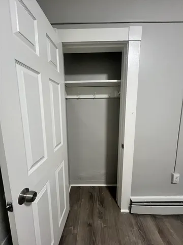 a view of walk in closet with wooden floor