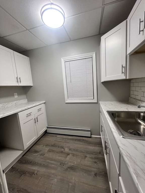 136-142 Bailey Street, Unit 2 Lawrence, MA 01843 - Photo 9 of 13 a kitchen with granite countertop white cabinets and white appliances