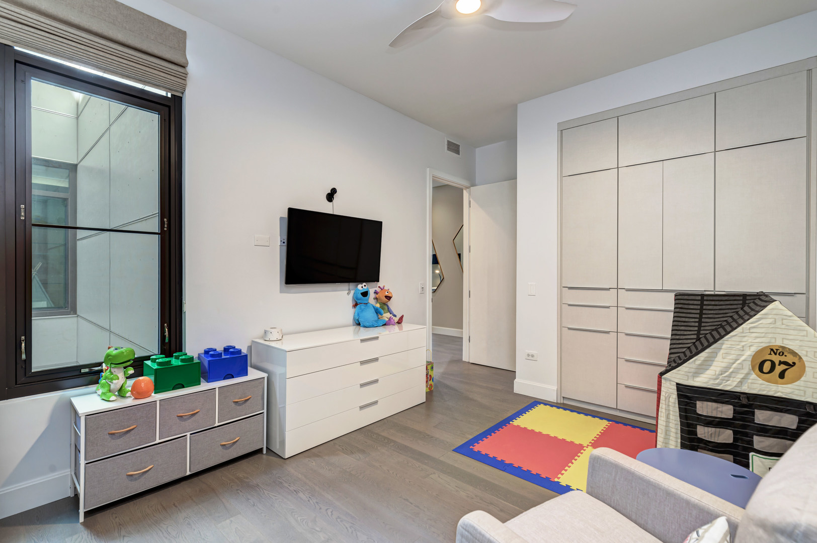 28 North Carpenter Street, Unit 3S Chicago, IL 60607 - Photo 35 of 37 a living room with furniture and a flat screen tv