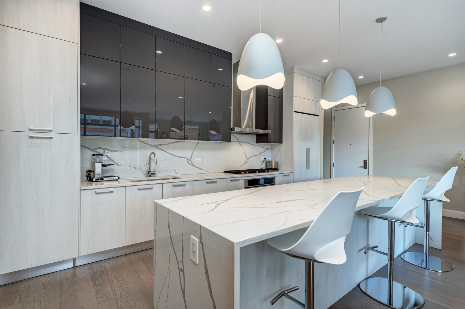 28 North Carpenter Street, Unit 3S Chicago, IL 60607 - Photo 7 of 37 a kitchen with a sink a stove and chairs