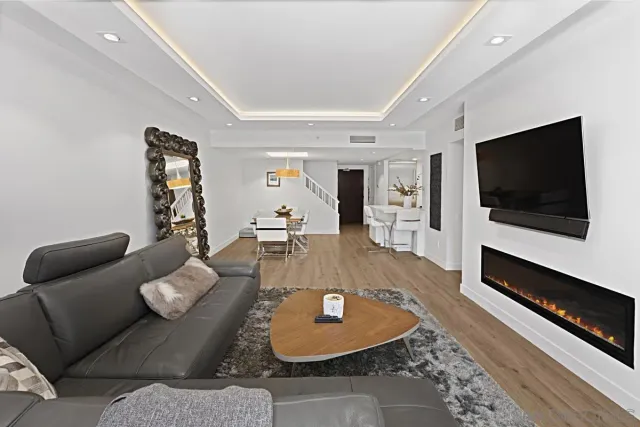 a living room with furniture and kitchen view