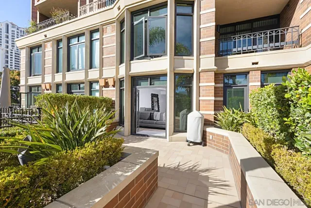 a living room with furniture large window and wooden floor