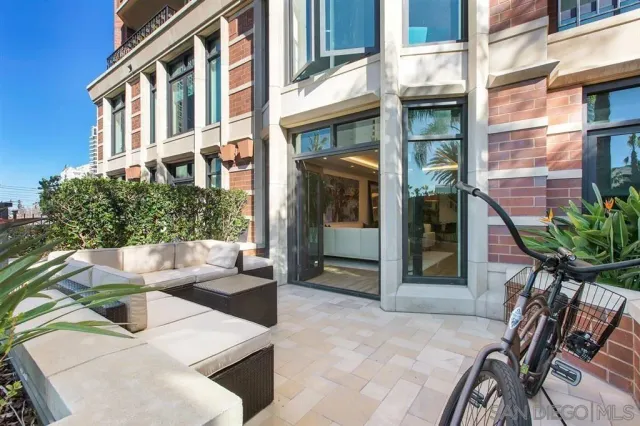 a living room with furniture a chandelier and a fireplace