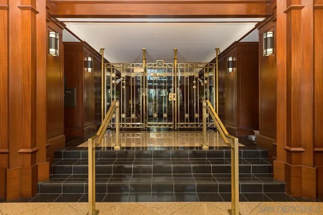 a view of a hallway with wooden floor and a living room