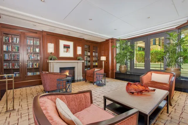 a living room with furniture a flat screen tv and a large window