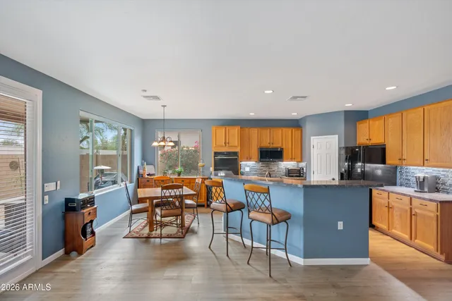 a living room with furniture a chandelier and a dining table