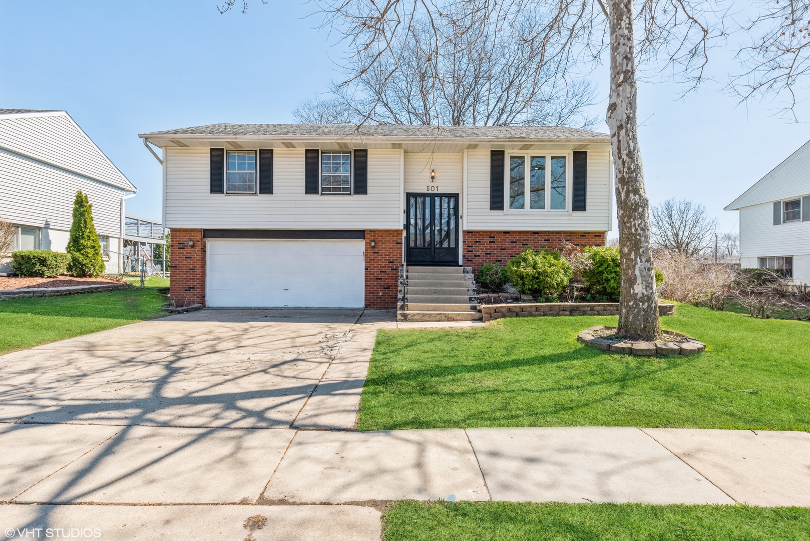 501 Ridge Circle Streamwood, IL 60107 - Photo 1 of 15 a front view of a house with a yard and garage