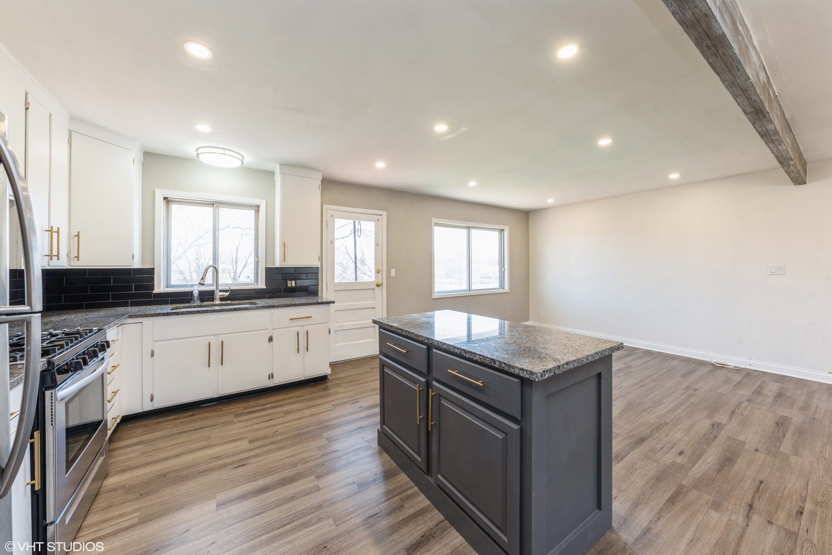 501 Ridge Circle Streamwood, IL 60107 - Photo 5 of 15 a kitchen with granite countertop counter top space a sink stainless steel appliances and windows