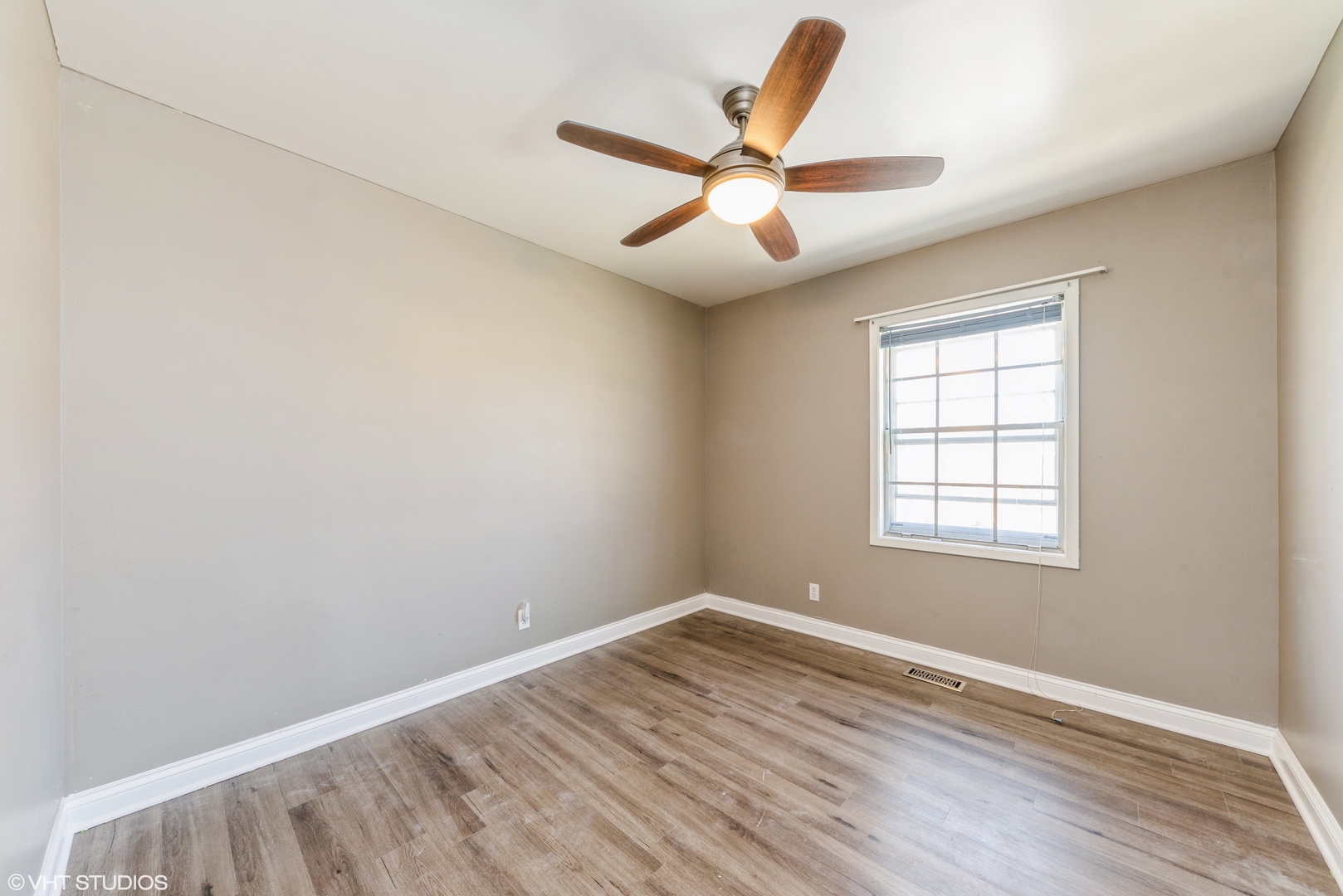 501 Ridge Circle Streamwood, IL 60107 - Photo 9 of 15 an empty room with wooden floor fan and windows