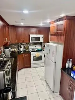 a kitchen with a stove a sink and a refrigerator