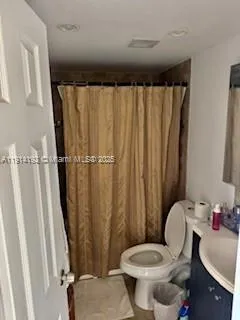 a white toilet sitting next to a bathroom sink
