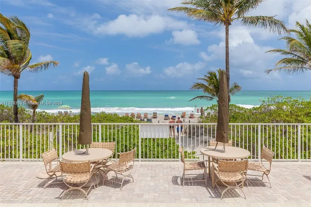 a view of a chair and table on the deck
