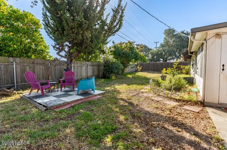 4220 Constellation Road Lompoc, CA 93436 - Photo 21 of 22 a view of backyard with wooden fence and a large tree