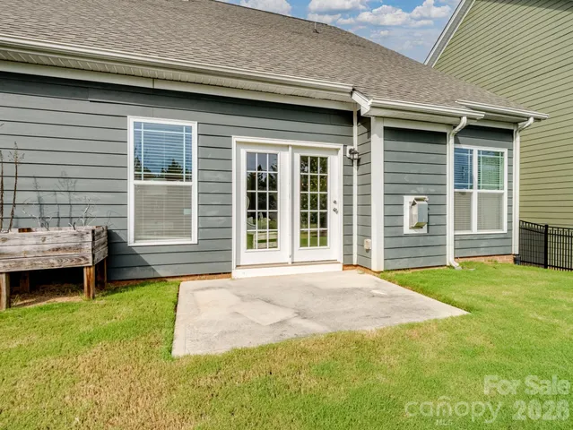 a view of a backyard that has a table and chairs in it