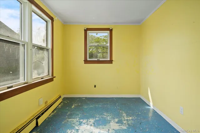 a view of a room with wooden floor and a window