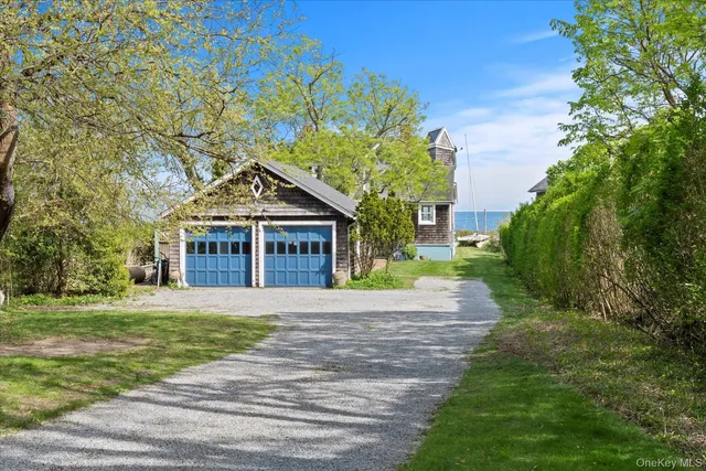 a front view of a house with a yard and trees
