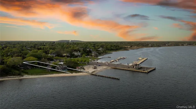 an aerial view of a house with yard and green space