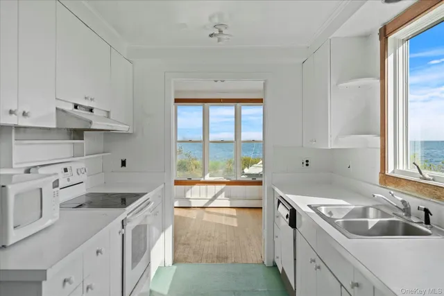 a kitchen that has a sink and a stove