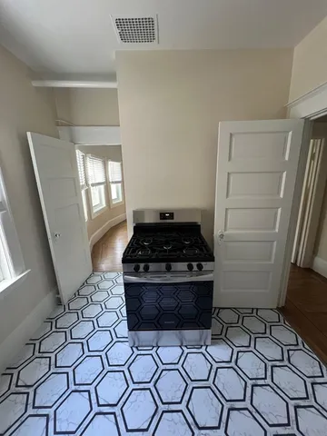 a stove top oven sitting inside of a kitchen