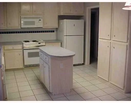 a kitchen with a sink cabinets and appliances