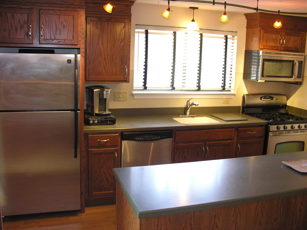 78 Mountain Gate Road, Unit 78 Ashland, MA 01721 - Photo 3 of 17 a kitchen with a refrigerator and a sink