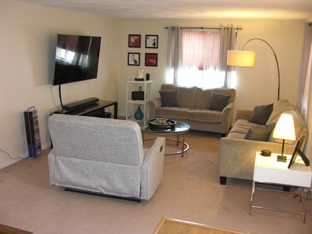 78 Mountain Gate Road, Unit 78 Ashland, MA 01721 - Photo 6 of 17 a living room with furniture and a flat screen tv