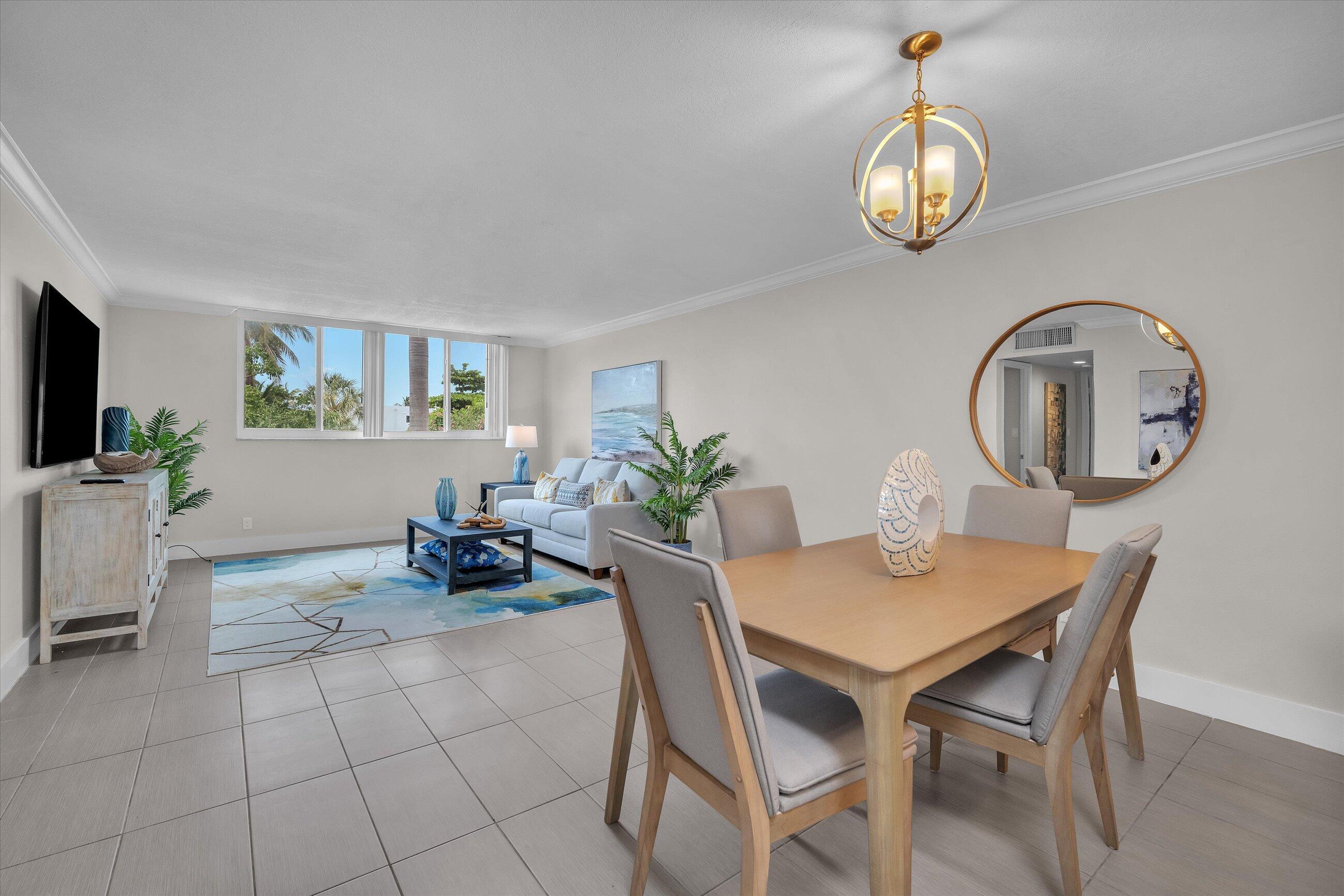 601 North Ocean Boulevard, Unit 203 Boca Raton, FL 33432 - Photo 7 of 20 a view of a dining room with furniture and wooden floor
