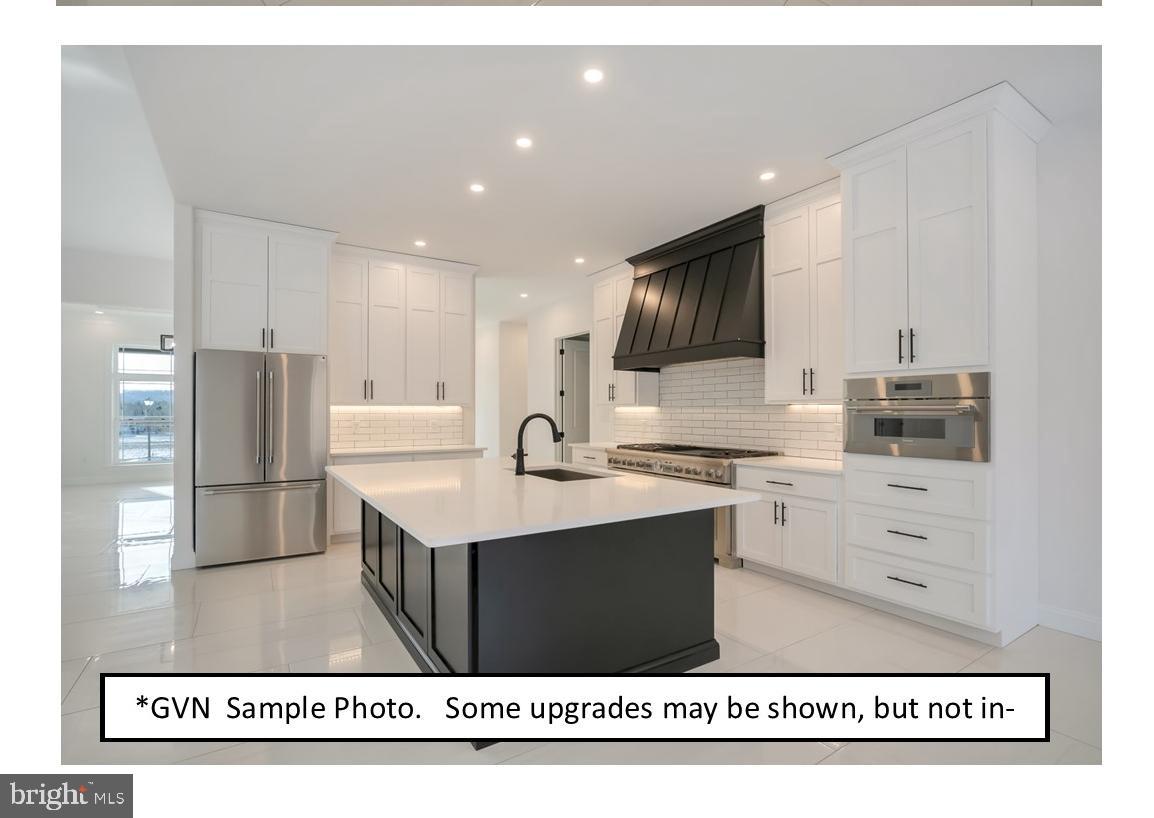 13 Ligaro Way Sinking Spring, PA 19608 - Photo 11 of 12 a kitchen with kitchen island a sink stainless steel appliances and cabinets