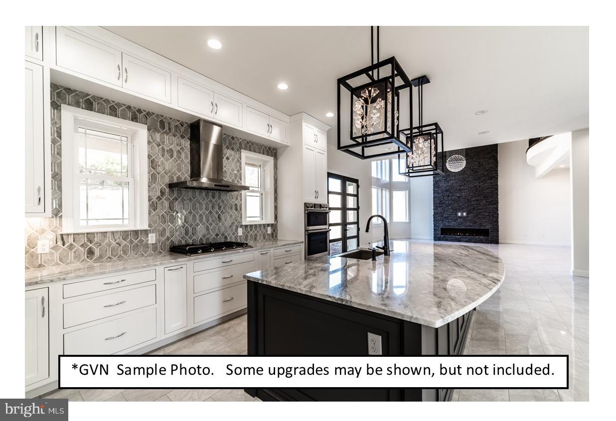 13 Ligaro Way Sinking Spring, PA 19608 - Photo 3 of 12 a kitchen with kitchen island granite countertop a stove a sink and a granite counter top