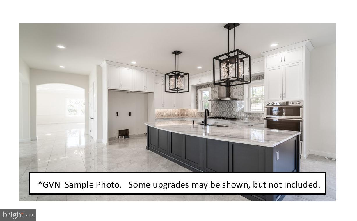 13 Ligaro Way Sinking Spring, PA 19608 - Photo 5 of 12 a kitchen with kitchen island granite countertop a sink and cabinets
