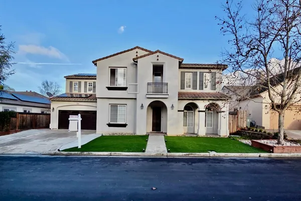 a front view of house with yard and green space