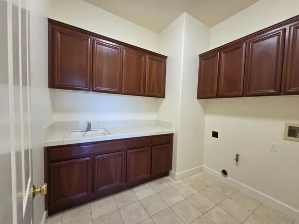 a kitchen with cabinets and window