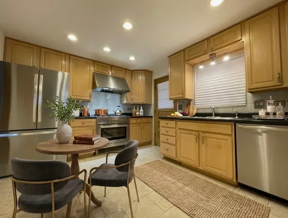 a kitchen with kitchen island granite countertop a sink stove and refrigerator