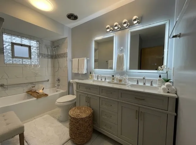 a bathroom with a toilet sink and mirror